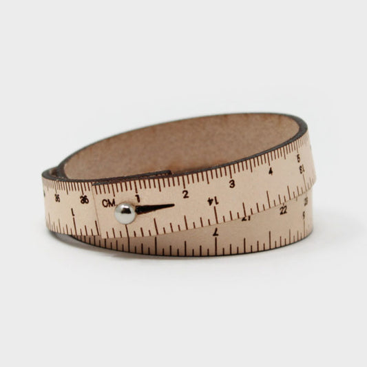 A natural leather wristband with engraved inch and centimeter measurements. If you find yourself always needing to measure things when you're on the go, this is perfect for you! Sizes are based on wrapping around your wrist twice. The stud closure is nickel-free, made from chrome-plated brass. Different sizes available.