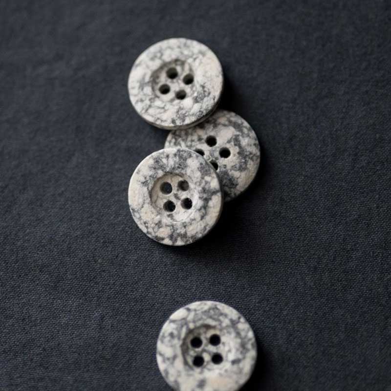 18mm or 20mm recycled resin button with 4 holes. These buttons are made from 70-80% recycled cotton fibres. Because the buttons are made from recycled fibre they will never be exactly the same. Sold individually. Made in Italy.