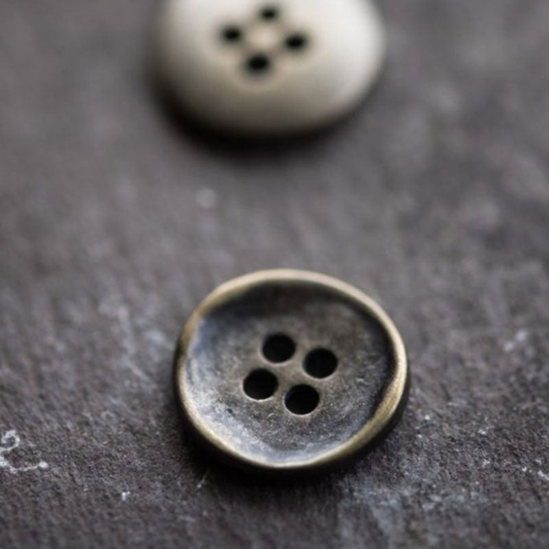 4 hole metal button. Tarnished bronze shade. Sold individually. Made in Italy.