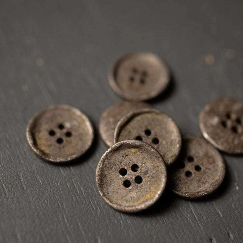 4 hole metal button with a rust effect, 20mm. Please note these buttons have a coating so the rust won't transfer. Sold individually. Made in Italy.