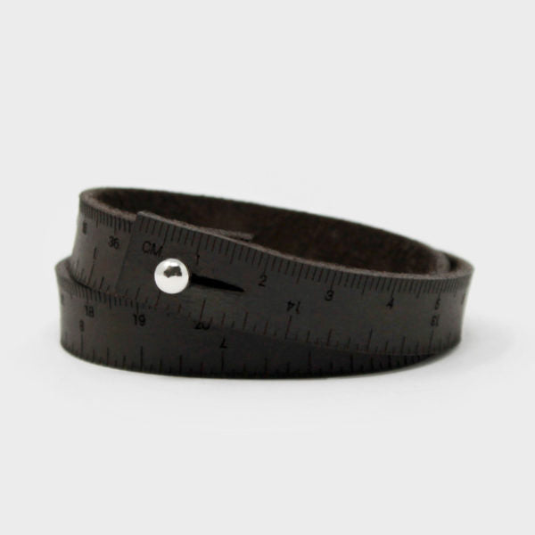 Leather wristband in dark brown with engraved inch & centimeter measurements. Perfect if you find yourself always needing to measure things when you're on the go. Sizes are based on wrapping around your wrist twice. The stud closure is nickel-free, made from chrome-plated brass. Different sizes available.