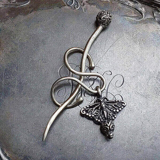Filigree Monarch Charm Lock Shawl Pin by JUL Designs in white brass. New shawl pin concept with a serpentine-shaped element that can accommodate a charm that can be slid on and off and then 'locked' in place with the stick. Pin may be worn on its own without a charm for a sleek elegant statement. Hand-made Fair Trade.