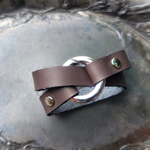 Bezel Leather Shawl Cuff by JUL Designs. Genuine leather available in black, espresso, pewter, bark, and plum. Ring available in glossy nickel or satin finished antique brass. Length: approx 330 mm (13"), circumference when wrapped approx 165 mm( 6.5").