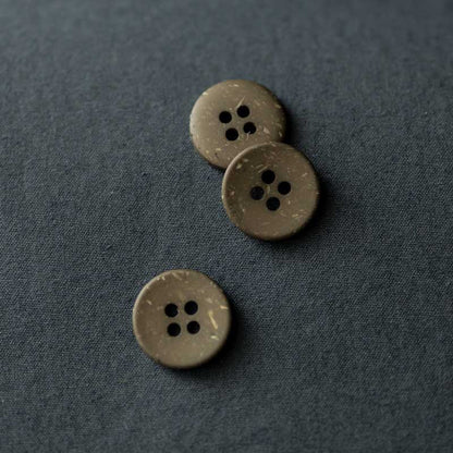 18mm recycled resin button with 4 holes. Available in the following colours: Brick, Ink and Olive. These buttons are made from 10% wooden wastage. Sold individually. Made in Italy. Depicted here in Olive.