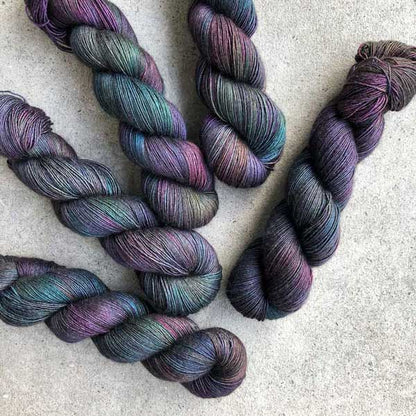 This yarn is hand painted with 12 colours. Colourway: Oil Slick. Available in Sikkim 4ply (singlespun 15% yak / 20% silk / 65% superwash merino), Mardi 4ply (20% yak / 20% silk / 60% superwash merino), Sinam 8ply (20% yak / 20% silk / 60% superwash merino), and Kashi 4ply (50% silk / 50% superwash merino).